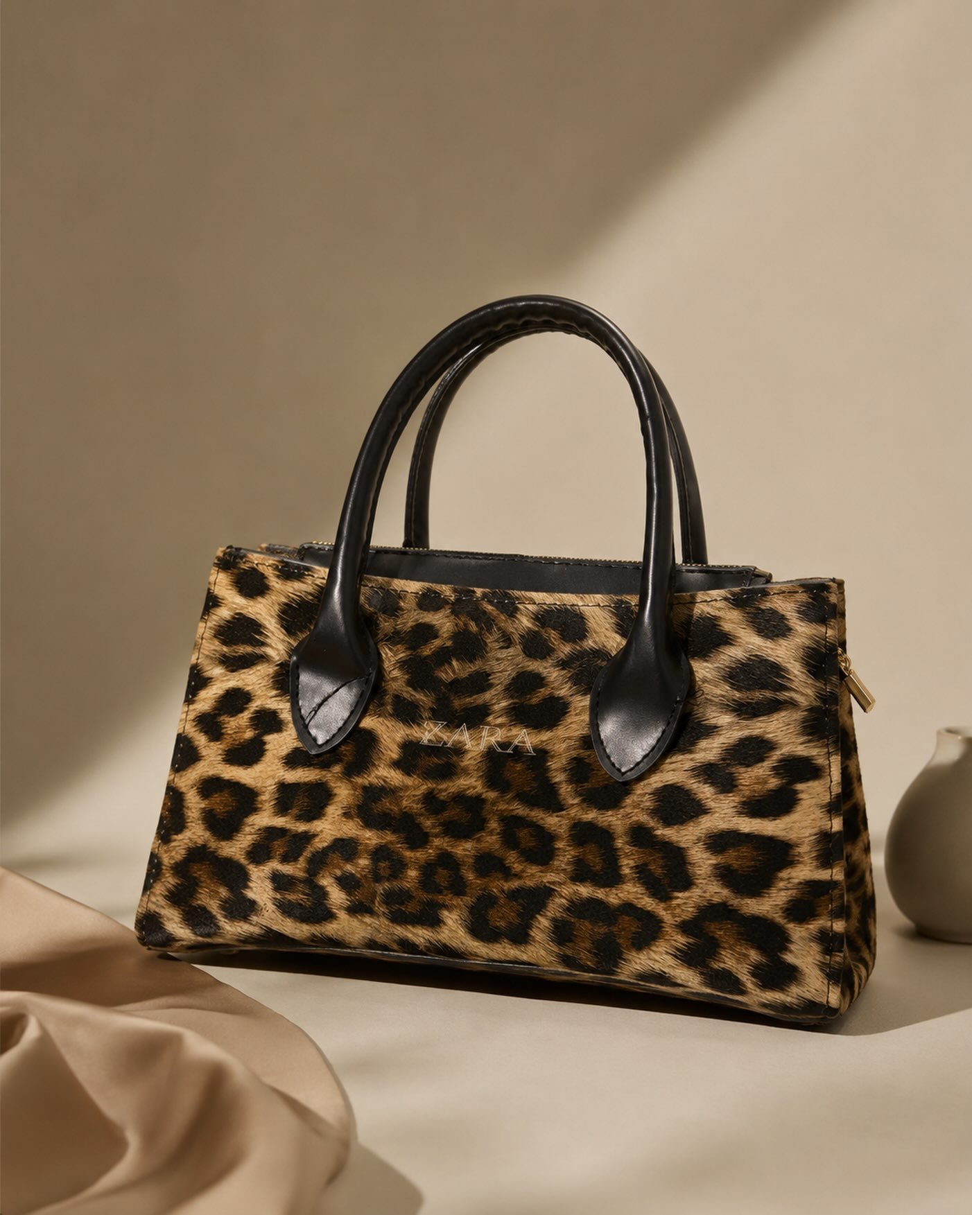 Leopar desenli, siyah saplı el çantası